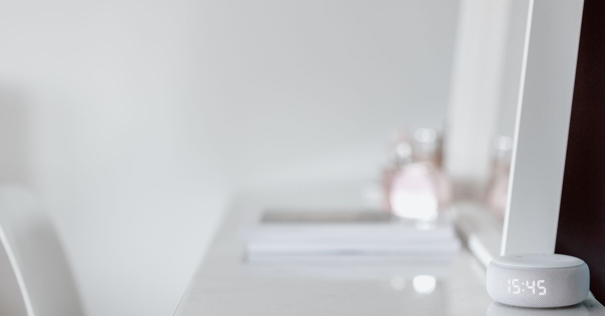 A sleek smart speaker on a minimalist desk with ample copy space, conveying modern simplicity.